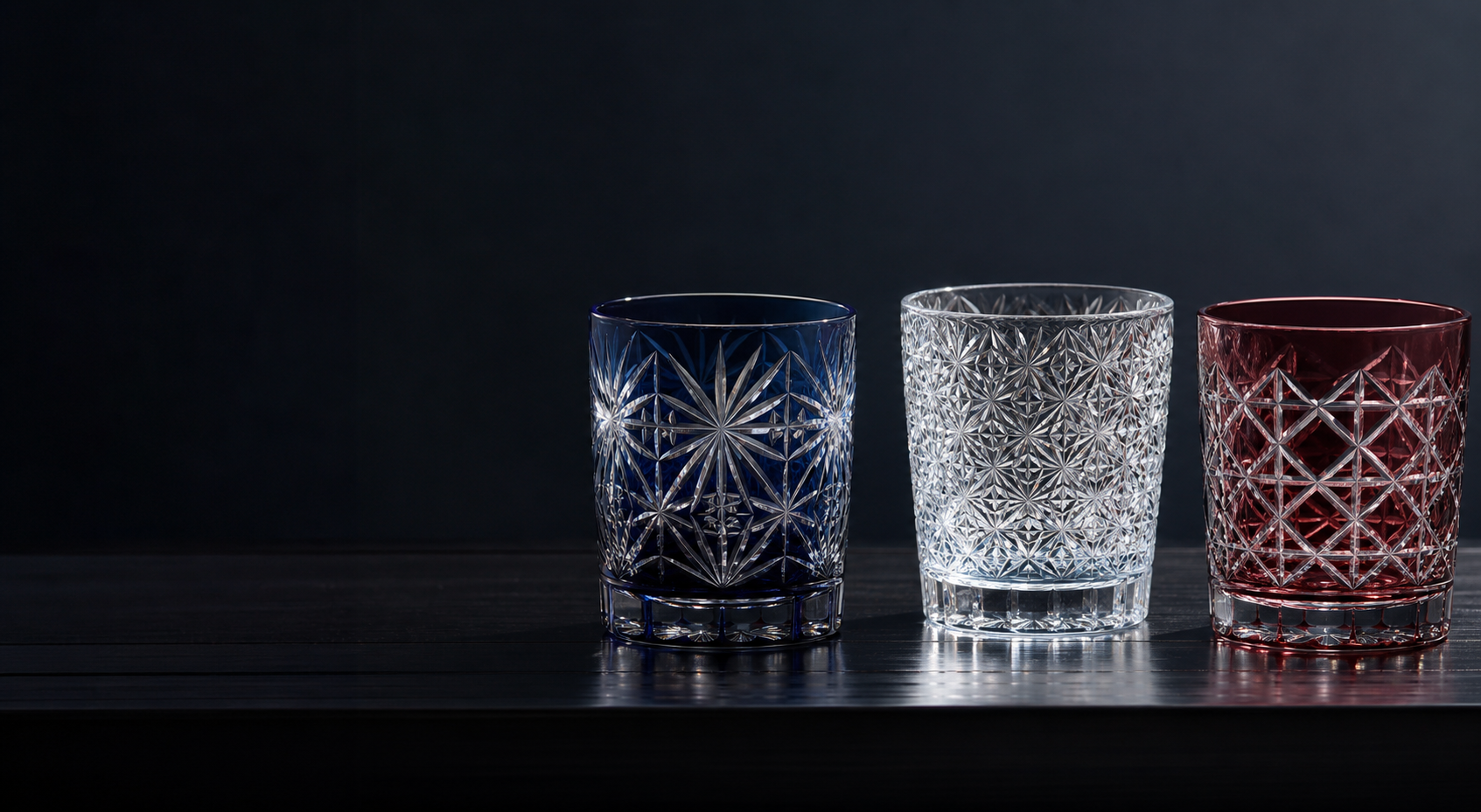 Three SANMENMO-inspired cut glass tumblers in indigo, clear crystal, and garnet